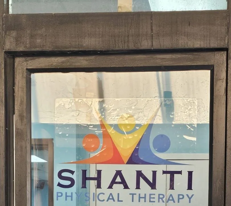 Glass entrance door with the Shanti Physical Therapy logo.