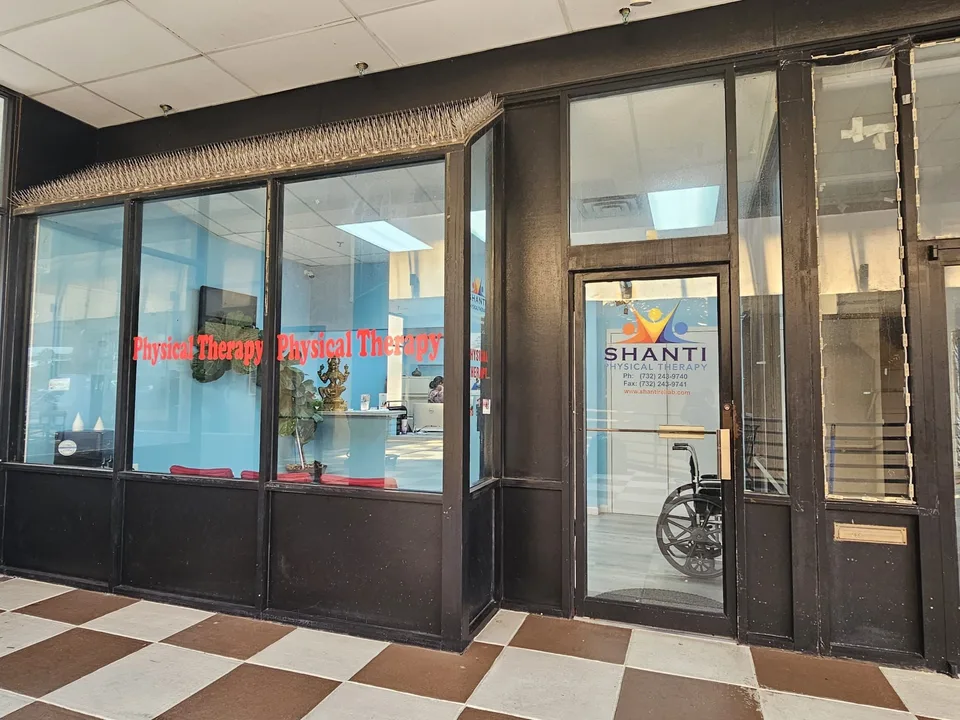 Shanti Physical Therapy's storefront window and entrance door in a covered shopping walkway.